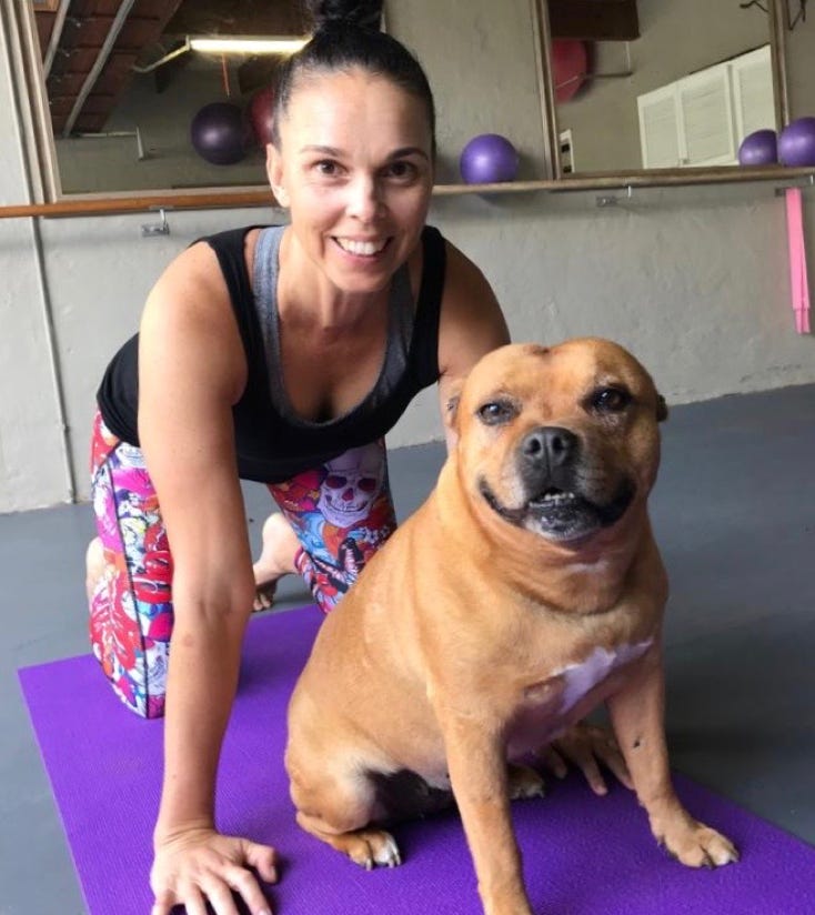 Alex Zehmke with dog in Pilates studio